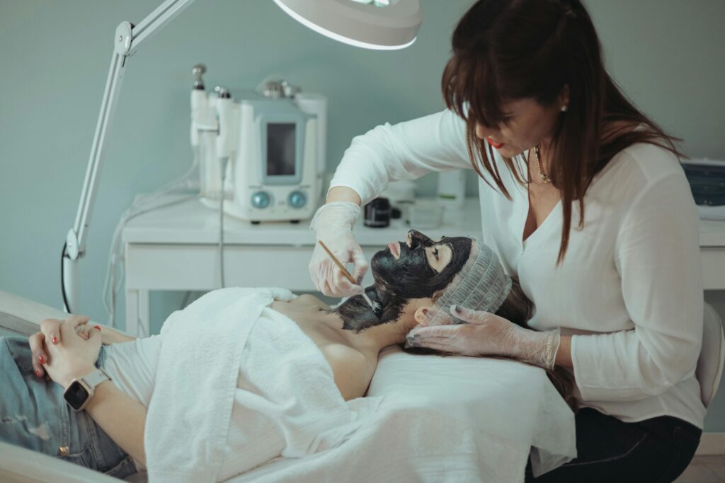 Woman receiving a rejuvenating facial treatment at a serene spa in Greece.